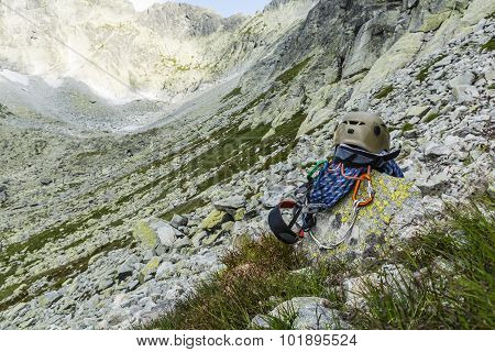 Rope, Helmet, Carabiners, Climbing Harness And Descender On A Rock In The Valley