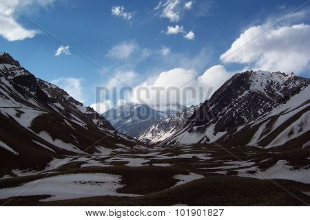 Aconcagua between clouds and mountains
