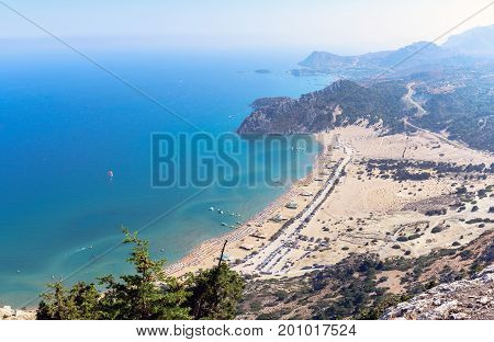 Aerial view on Tsampika sandy beach and lagoon with clear blue water at Rhodes island, Greece.