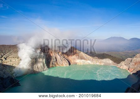 Colorful Ijen Volcano Crater Lake And Raung Volcano At The Background. Indonesia.
