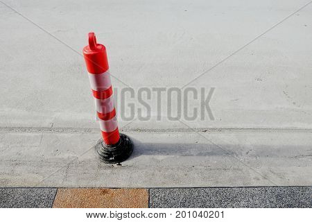 Road sign flexible plastic bollard on the street