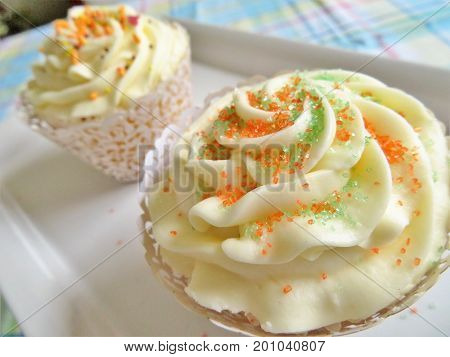 Cupcakes decorated with a vanilla frosting and sprinkles for birthdays weddings or showers