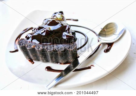 Chocolate cake with chocolate cream on plate