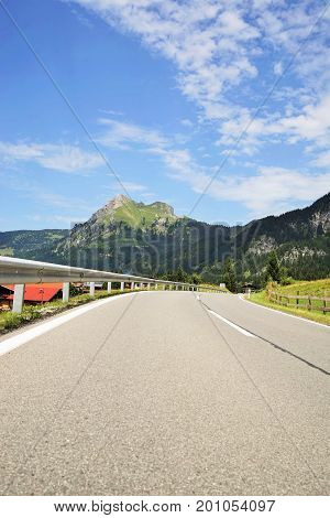 Road in the Tyrolean Alps in the direction of the mountain Aggenstein