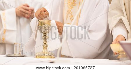 Priest during a wedding ceremony/nuptial mass (shallow DOF; color toned image)