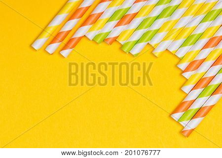 close-up colorful fancy drinking straws fancy tube for party on the yellow background