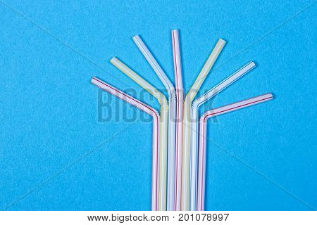 close-up colorful fancy drinking straws fancy tube for party on the blue background