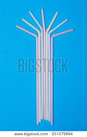 close-up colorful fancy drinking straws fancy tube for party on the blue background