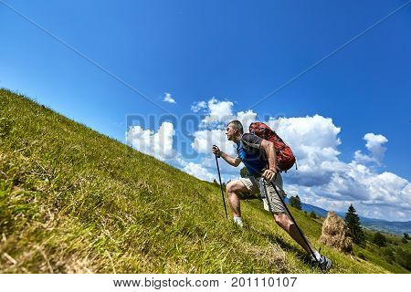 Hiking in the mountains with a backpack in the summer.