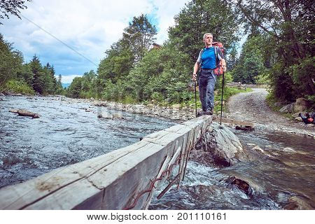 Hiking in the mountains with a backpack in the summer.