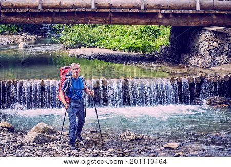 Hiking in the mountains with a backpack in the summer.