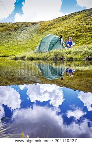 Hiking in the mountains with a backpack in the summer.