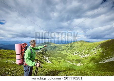 Hiking in the mountains with a backpack in the summer.