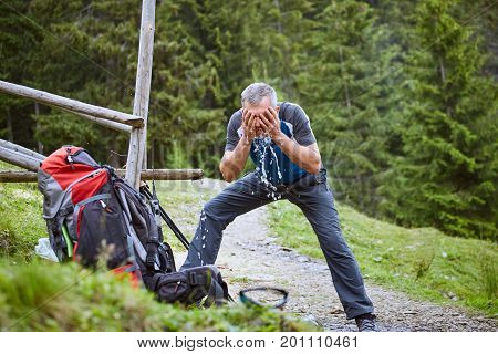 Hiking in the mountains with a backpack in the summer.
