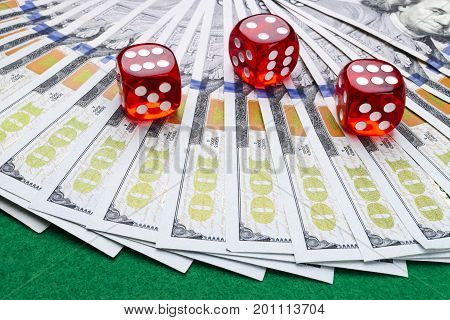 Poker dice rolls on a dollar bills Money. Poker table at the casino. Poker game concept. Playing a game with dice. Casino dice rolls. Concept for business risk. chance good luck