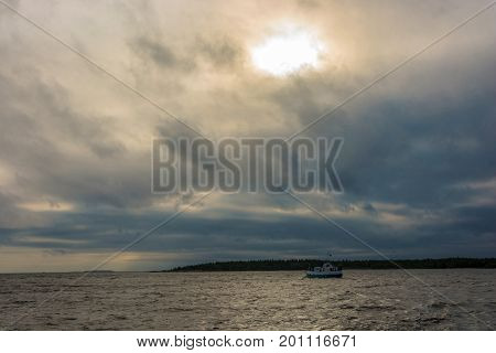 A small boat in Onezhskaya Guba in cloudy stormy day.
