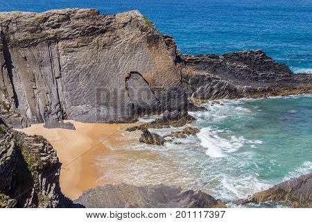 Wave And Cliffs In The Beach In Almograve