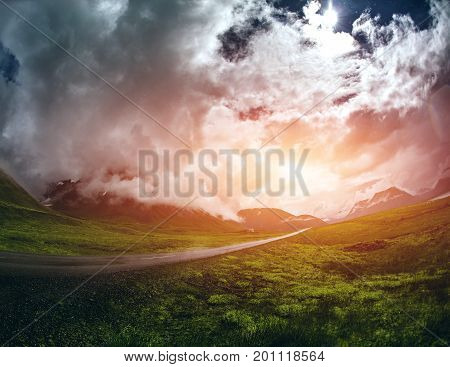 Travel to Iceland. A mountain road with fog and clouds to the town of Isafjordur and a view of the fjord after rain. focus on the road. toned image