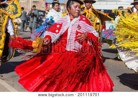 PUNO, PERU - AUGUST 07: Authentic Colorful Carnival on the streets of Puno, Peru near the high altutude Titicaca lake on August 7th, 2017