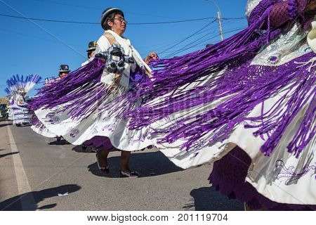 PUNO, PERU - AUGUST 07: Authentic Colorful Carnival on the streets of Puno, Peru near the high altutude Titicaca lake on August 7th, 2017