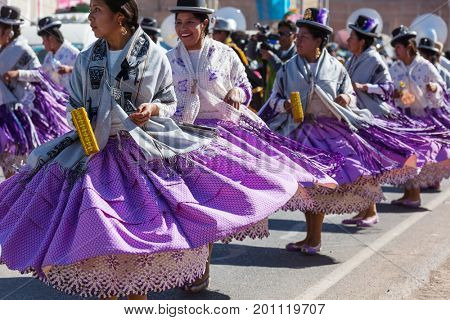 PUNO, PERU - AUGUST 07: Authentic Colorful Carnival on the streets of Puno, Peru near the high altutude Titicaca lake on August 7th, 2017