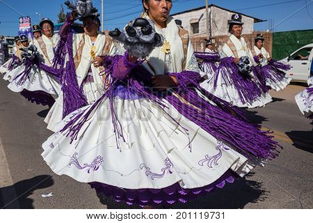 PUNO, PERU - AUGUST 07: Authentic Colorful Carnival on the streets of Puno, Peru near the high altutude Titicaca lake on August 7th, 2017