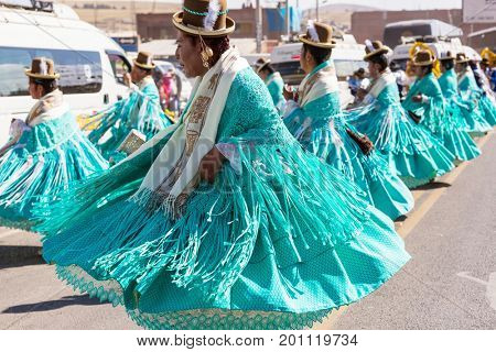 PUNO, PERU - AUGUST 07: Authentic Colorful Carnival on the streets of Puno, Peru near the high altutude Titicaca lake on August 7th, 2017