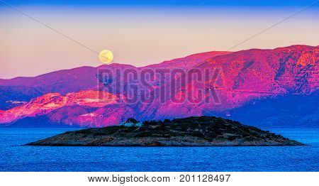 Full moon over the island of Crete at sunset Mirabello Bay Crete Greece