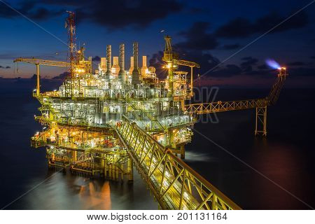 Offshore oil and gas industry in the gulf of Thailand Oil and Gas central processing platform and flare platform in twilight scene.