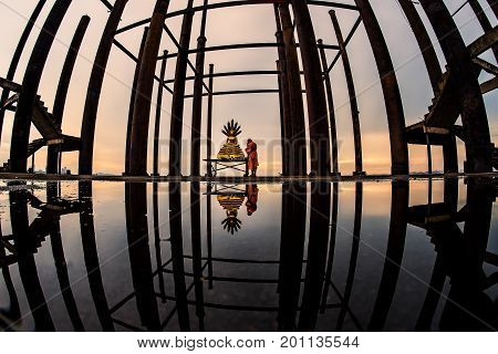 Buddha statue with reflection on water in the evening