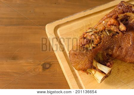 Schweinshaxe (german crispy pork knuckle) on a cutting board