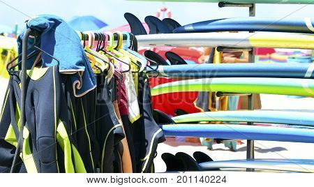 Surfboards and uniforms on the beach of Atlantic ocean at the surf school