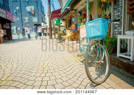 TOKYO, JAPAN JUNE 28 - 2017: Old rusted bicycle in Komachi-dori Street, in Kamakura in Tokyo Japan, a stylish street in the ancient city of Kamakura With historic restaurants and fashionable stores.