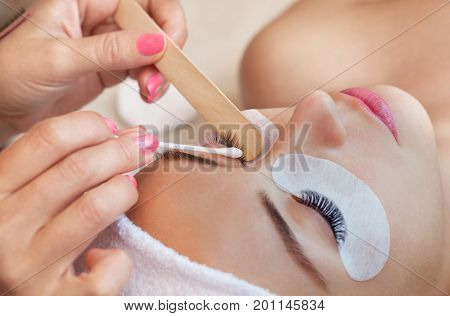 Eyelash Removal Procedure Close Up. Beautiful Woman With Long Lashes In A Beauty Salon. Eyelash Exte