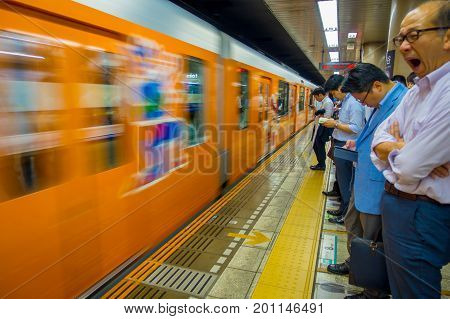 TOKYO, JAPAN - CIRCA MAY 2014: Crowd of people hurry at Ikebukuro station in Tokyo, Japan. Ikebukuru is the second-busiest railway station in the world.