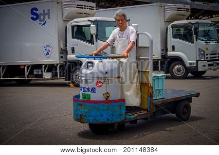 TOKYO, JAPAN JUNE 28 - 2017: Unidentified old man driving a cargo machine outside in Fish Tsukiji Market is the biggest wholesale fish and seafood market in the world, in Tokyo, Japan.