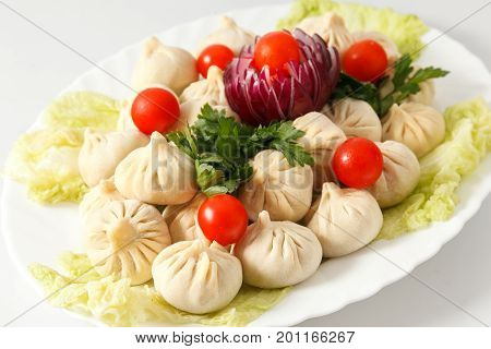 Frozen Dumplings On The White Plate With Green