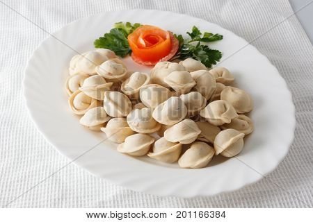 Frozen Dumplings On The White Plate With Green