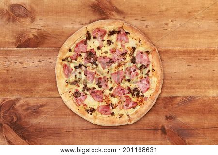 Pizza on wooden table top view. Fast food Delicious. Post blog social media. View from above with copy space. Banner template layout mockup top view on pizza. Pizza ready to eat.
