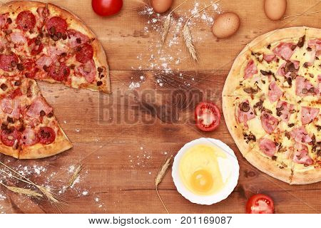 Pizza on wooden table top view. Fast food Delicious. Post blog social media. View from above with copy space. Banner template layout mockup top view on pizza. Pizza ready to eat.