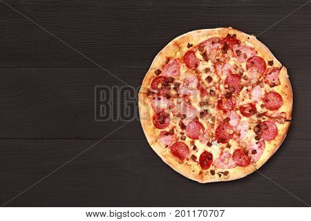 Pizza on wooden. Wooden table top view. On the table are the food for cooking. Healthy food. Dietetic foods. Above view on food. Hot Homemade Pepperoni Pizza Ready to Eat