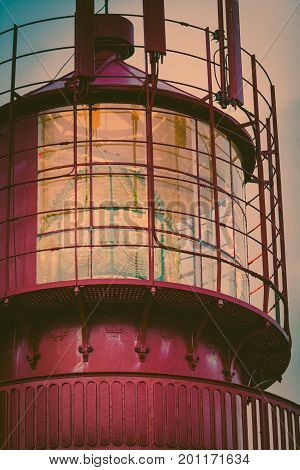 Historic red lighthouse on the edge of rocky sea coast South Norway Lindesnes Fyr beacon detail view