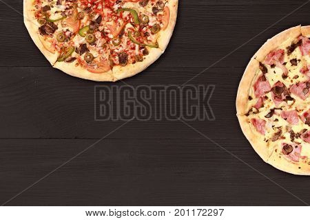 Pizza on wooden table top view. Fast food Delicious. Post blog social media. View from above with copy space. Banner template layout mockup top view on pizza. Pizza ready to eat.