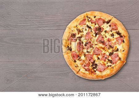 Pizza on wooden table top view. Fast food Delicious. Post blog social media. View from above with copy space. Banner template layout mockup top view on pizza. Pizza ready to eat.