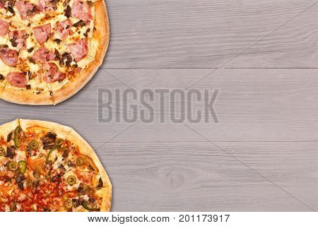 Pizza on wooden table top view. Fast food Delicious. Post blog social media. View from above with copy space. Banner template layout mockup top view on pizza. Pizza ready to eat.