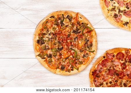 Pizza on wooden table top view. Fast food Delicious. Post blog social media. View from above with copy space. Banner template layout mockup top view on pizza. Pizza ready to eat.