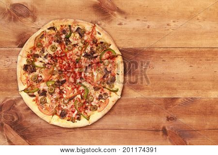 Pizza on wooden table top view. Fast food Delicious. Post blog social media. View from above with copy space. Banner template layout mockup top view on pizza. Pizza ready to eat.