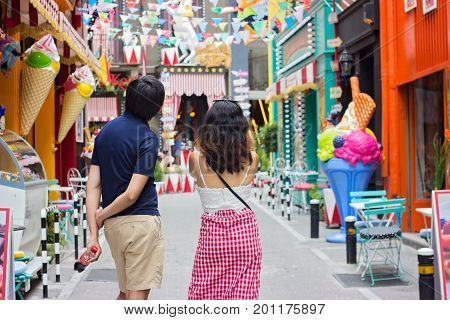 ATHENS GREECE - JULY 16 2017: Man and woman taking pictures of colorful decorated streets at Psiri area Athens city near Monastiraki
