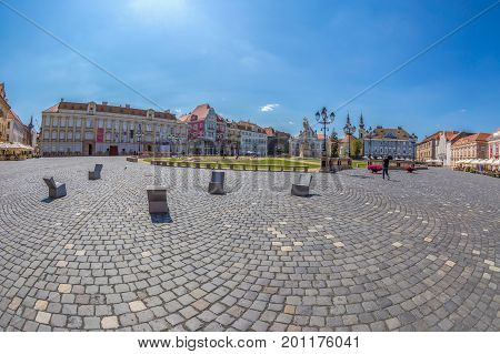 TIMISOARA ROMANIA - AUGUST 24 2017: View of one part at Union Square in Timisoara Romania with old buildings. Trinity Statue and serbian vicariate in background.