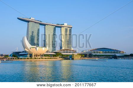 Singapore, Singapore - August 24, 2017: View at the Marina Bay in Singapore during the afternoon with the iconic landmarks of The Helix Bridge.